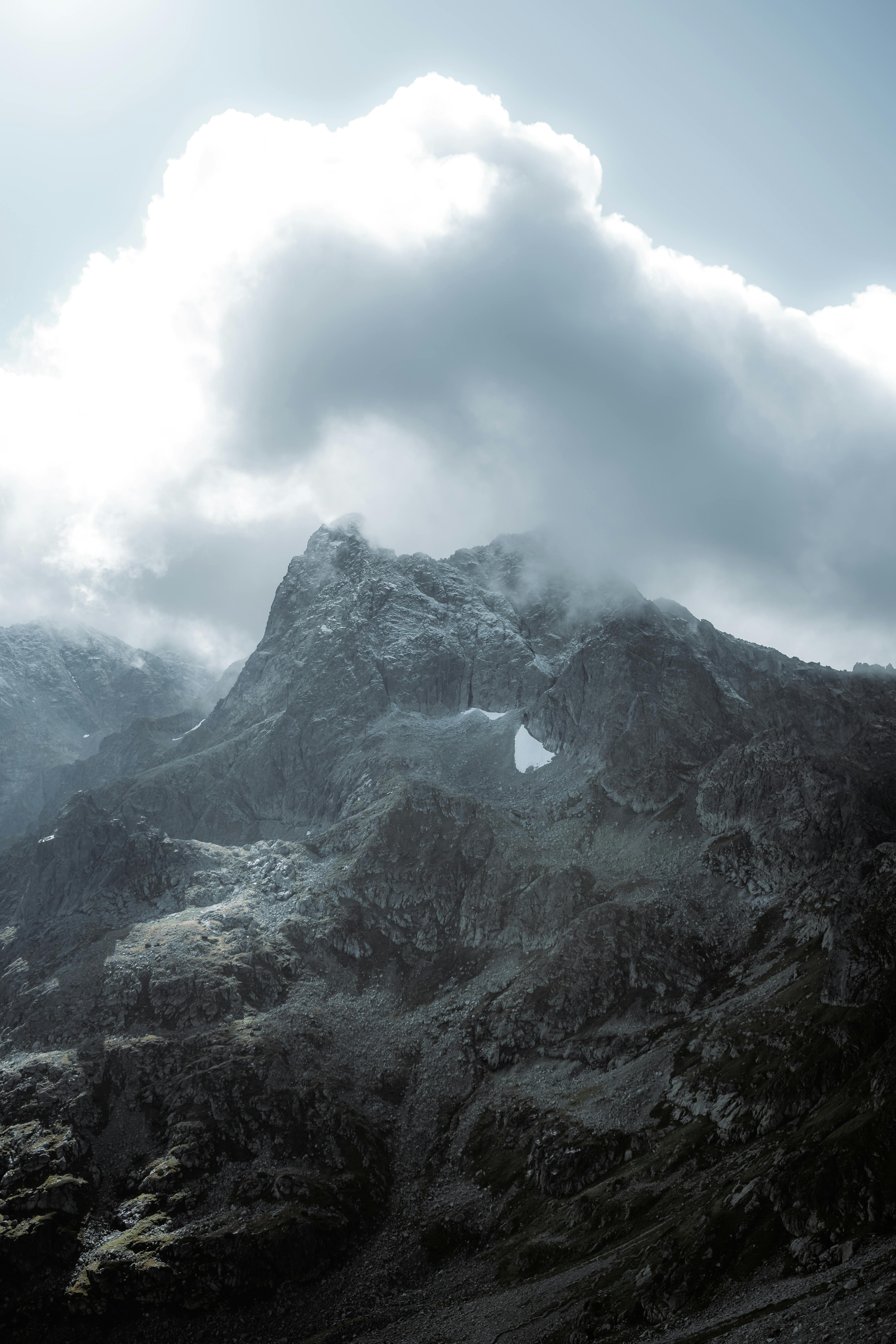 A scenic view of cloud-covered mountain peaks, showcasing nature's grandeur.