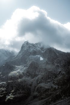 A scenic view of cloud-covered mountain peaks, showcasing nature's grandeur.