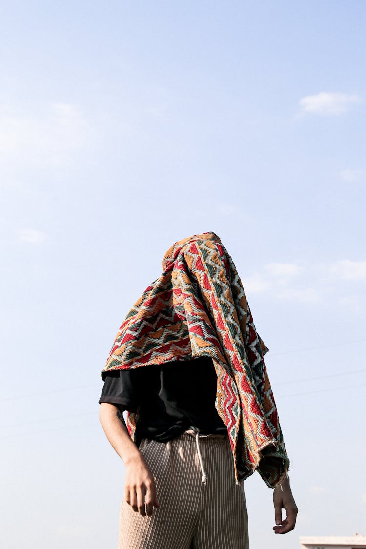 A Person With A Towel Covering Their Face
