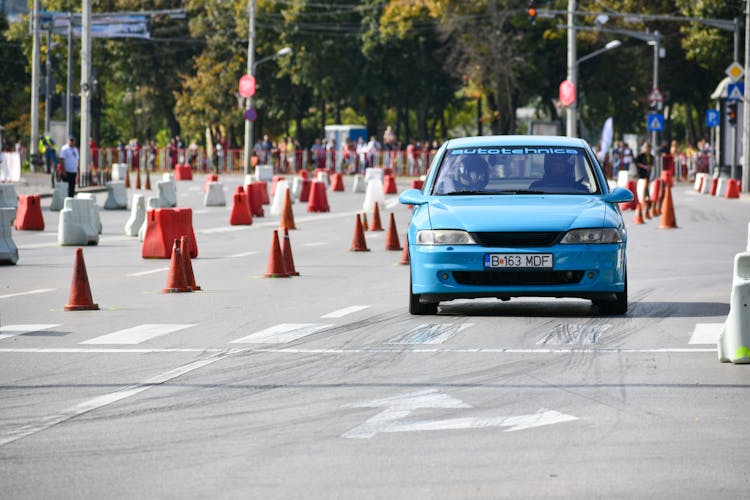 Blue Race Car Driving In Street Race