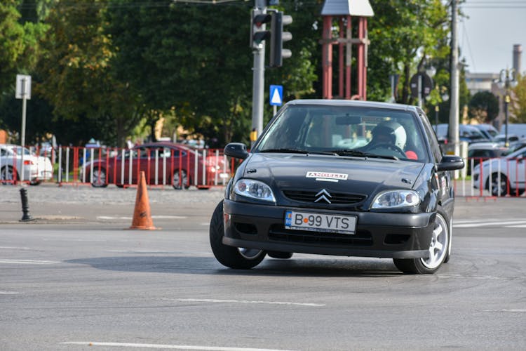 Driver In A Black Car Turning In A Race
