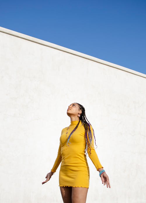 Woman in Yellow Dress Looking Up