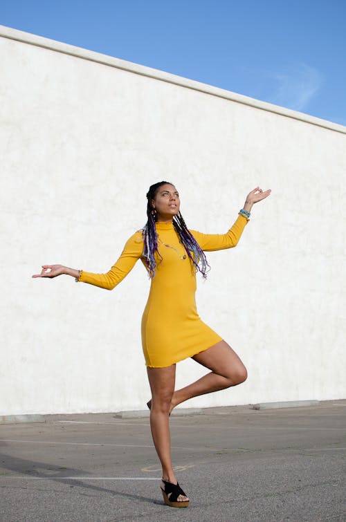 Woman in Yellow Dress Doing a Pose