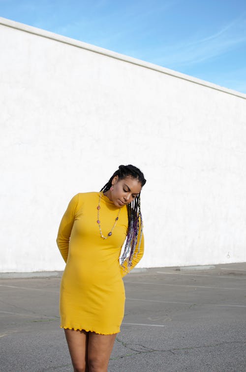 Woman in Yellow Long Sleeve Dress Standing