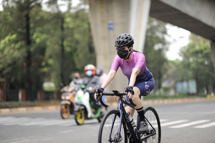 Woman Wearing Black Helmet RIding A Bicycle