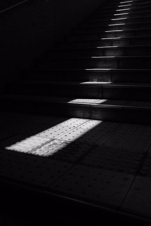 Black and White Photo of Sunlight in the Stairs