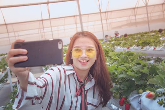 Woman Taking Photo in Front of Platns