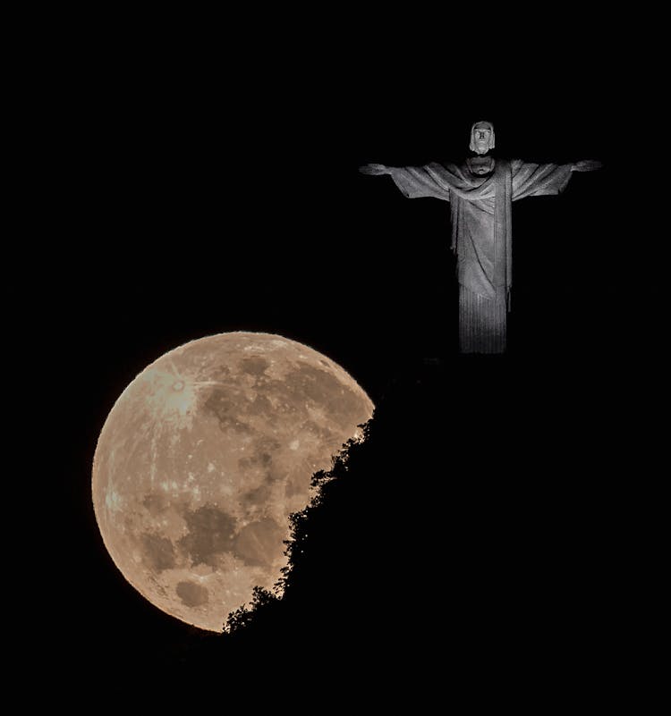 Christ The Redeemer Statue On A Full Moon Night, Rio De Janeiro, Brazil