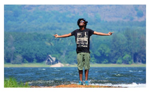 Man Spreading Arm on River Photograph