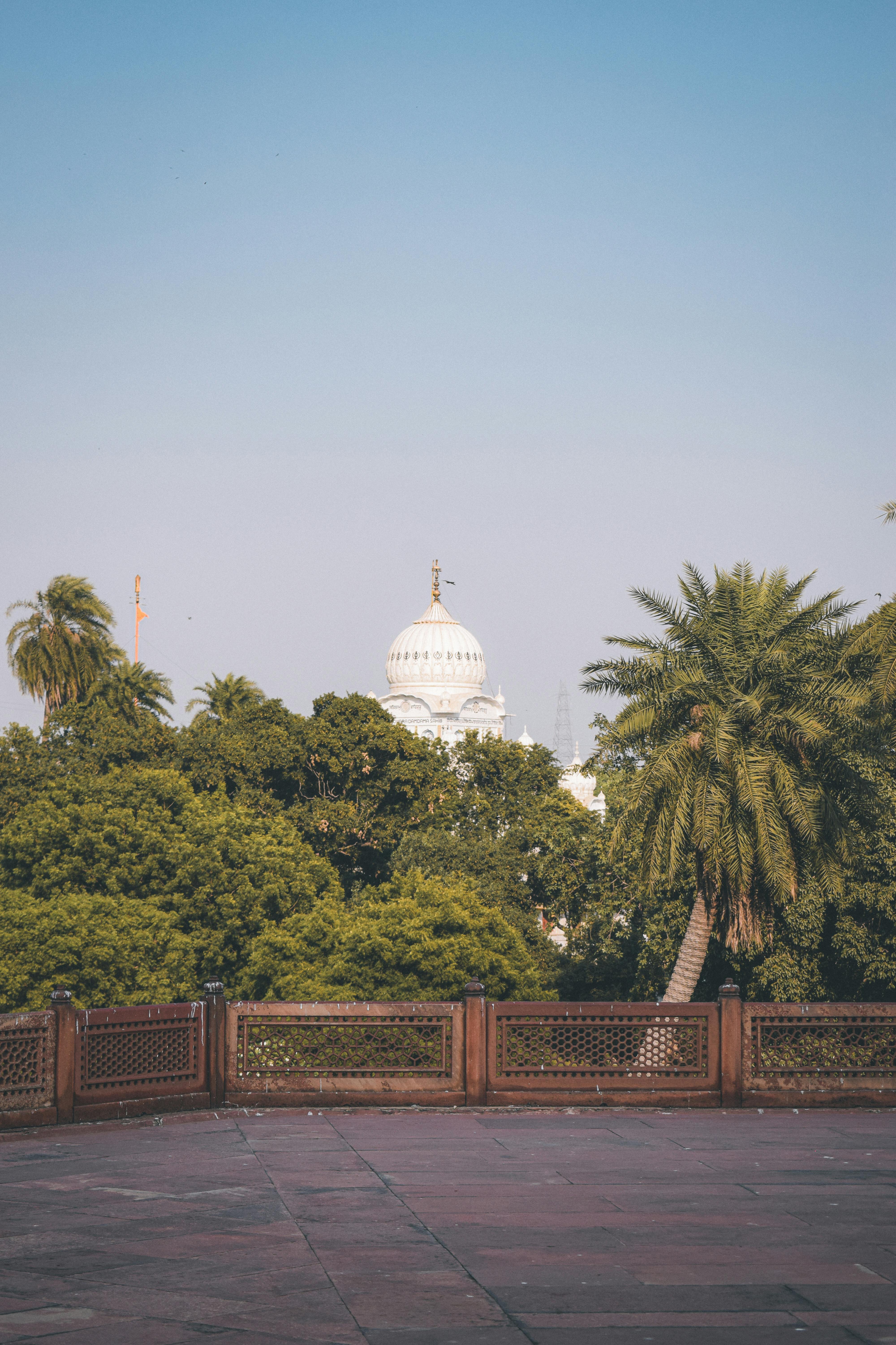 Scenic view of the Samadhi of Ranjit Singh dome amidst lush greenery in Lahore, Pakistan.