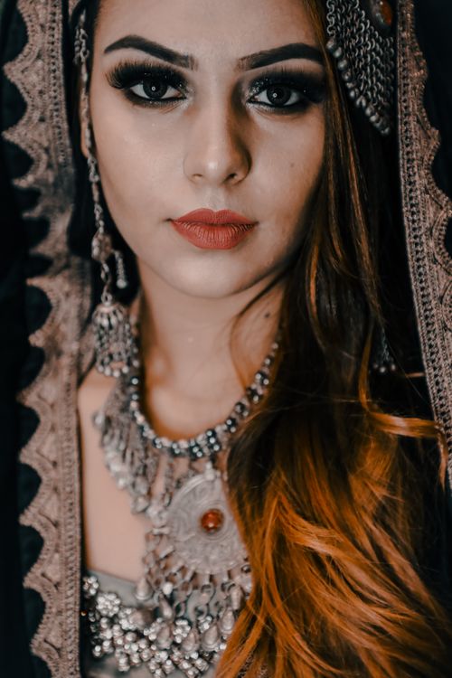 Free Close-up portrait of a woman in ornate traditional attire and jewelry. Stock Photo