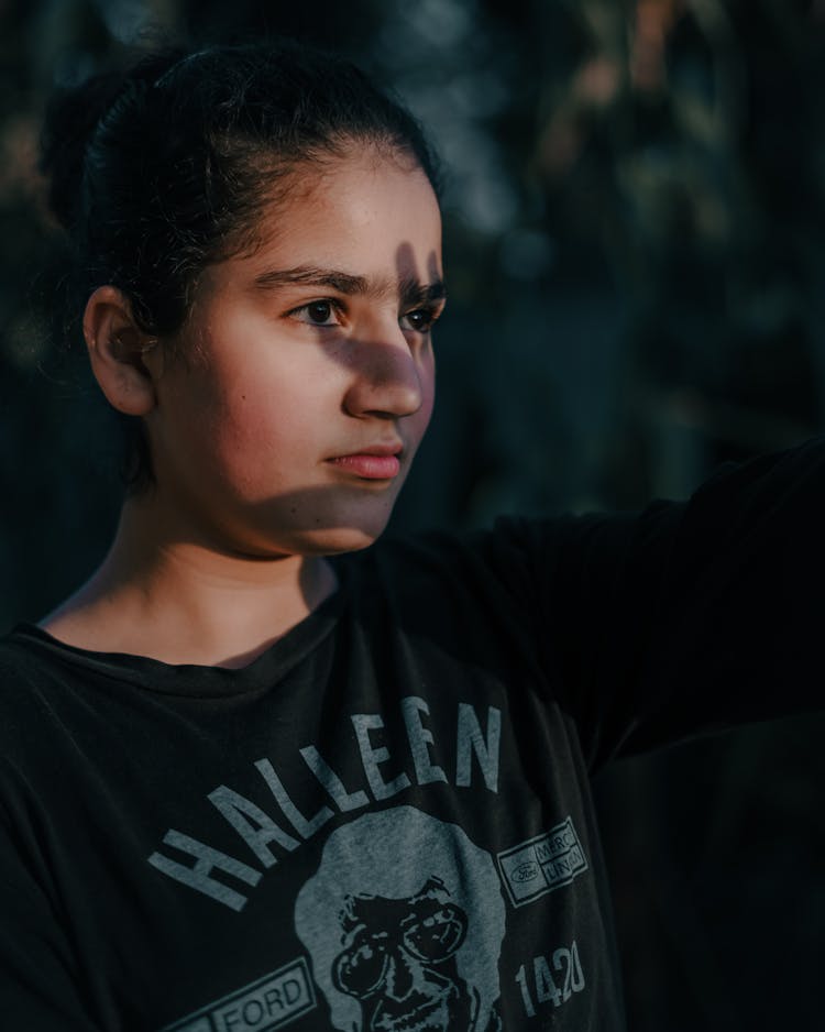 Young Girl With Shadow Of Her Hand On Her Fae