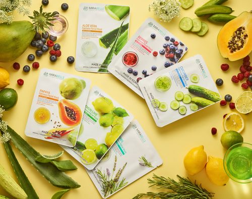 Free A collection of botanical face masks surrounded by fresh fruits and herbs on a yellow background. Stock Photo