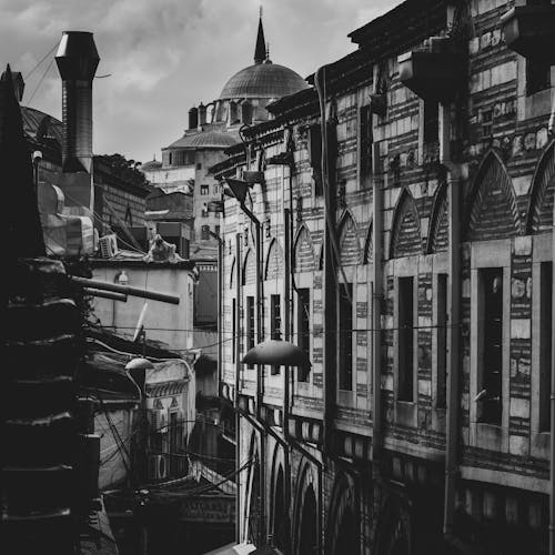 Facade of City Buildings and the Dome of a Mosque in the Distance