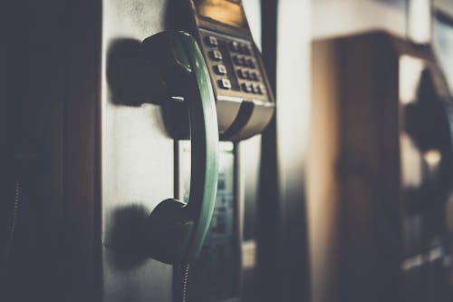 Selective Focus Photo of Green Telephone