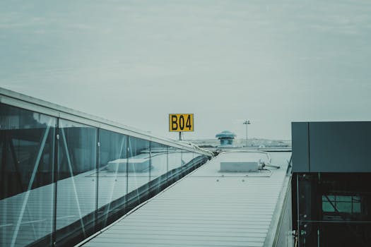 A contemporary view of an airport gate marked B04 with reflections on glass panels.