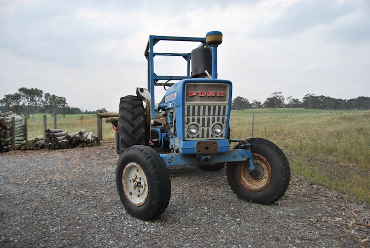 Old Ford Tractor On A Agricultural Land