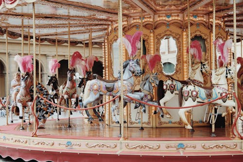 Free A Child Riding a Carousel Stock Photo