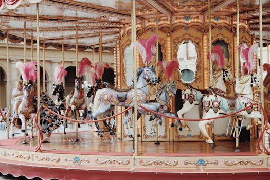 A beautifully decorated vintage carousel with ornate horse figures in a lively fairground setting.