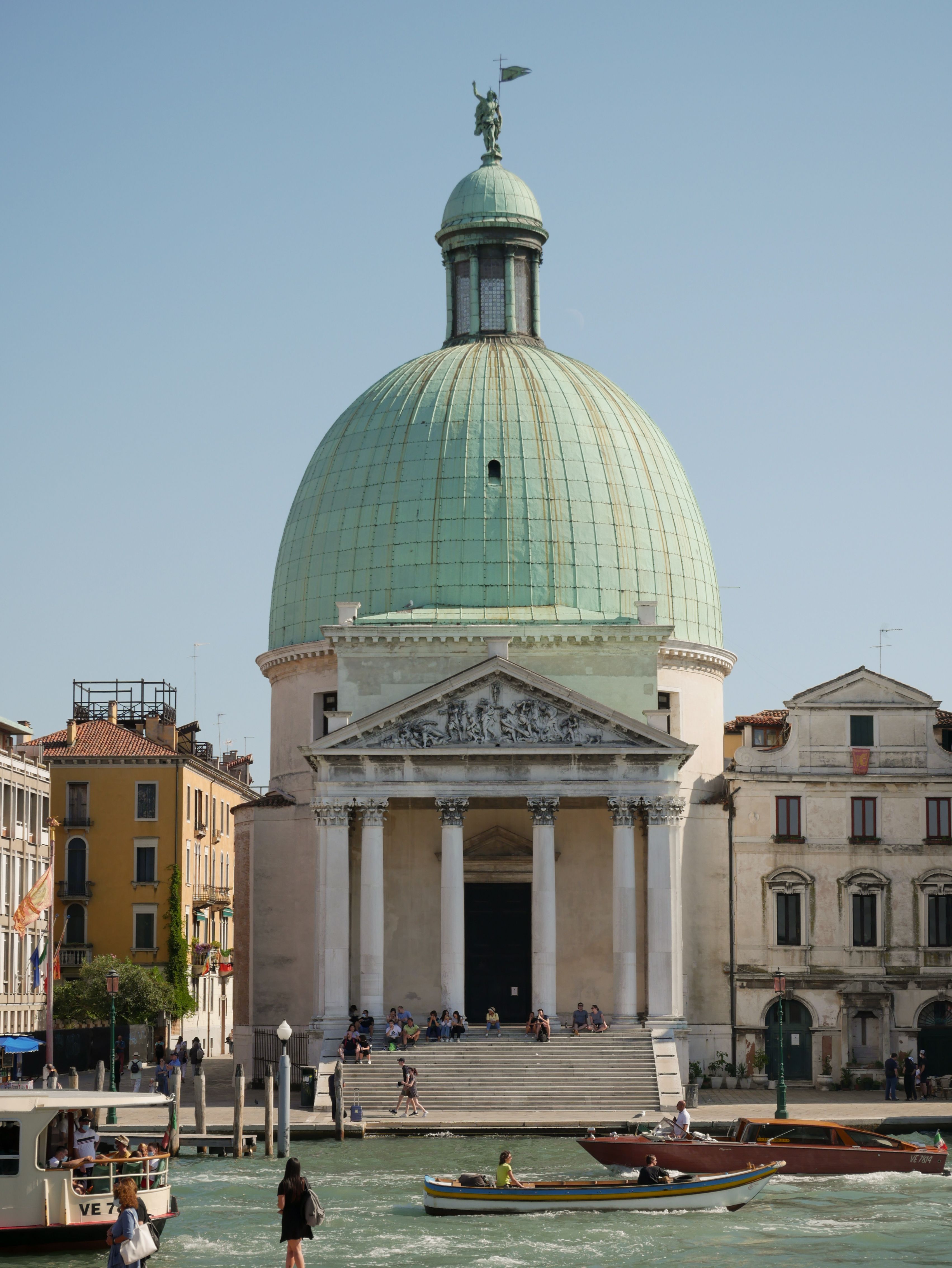 Iconic San Simeone Piccolo church and canal scene in Venice on a sunny day.