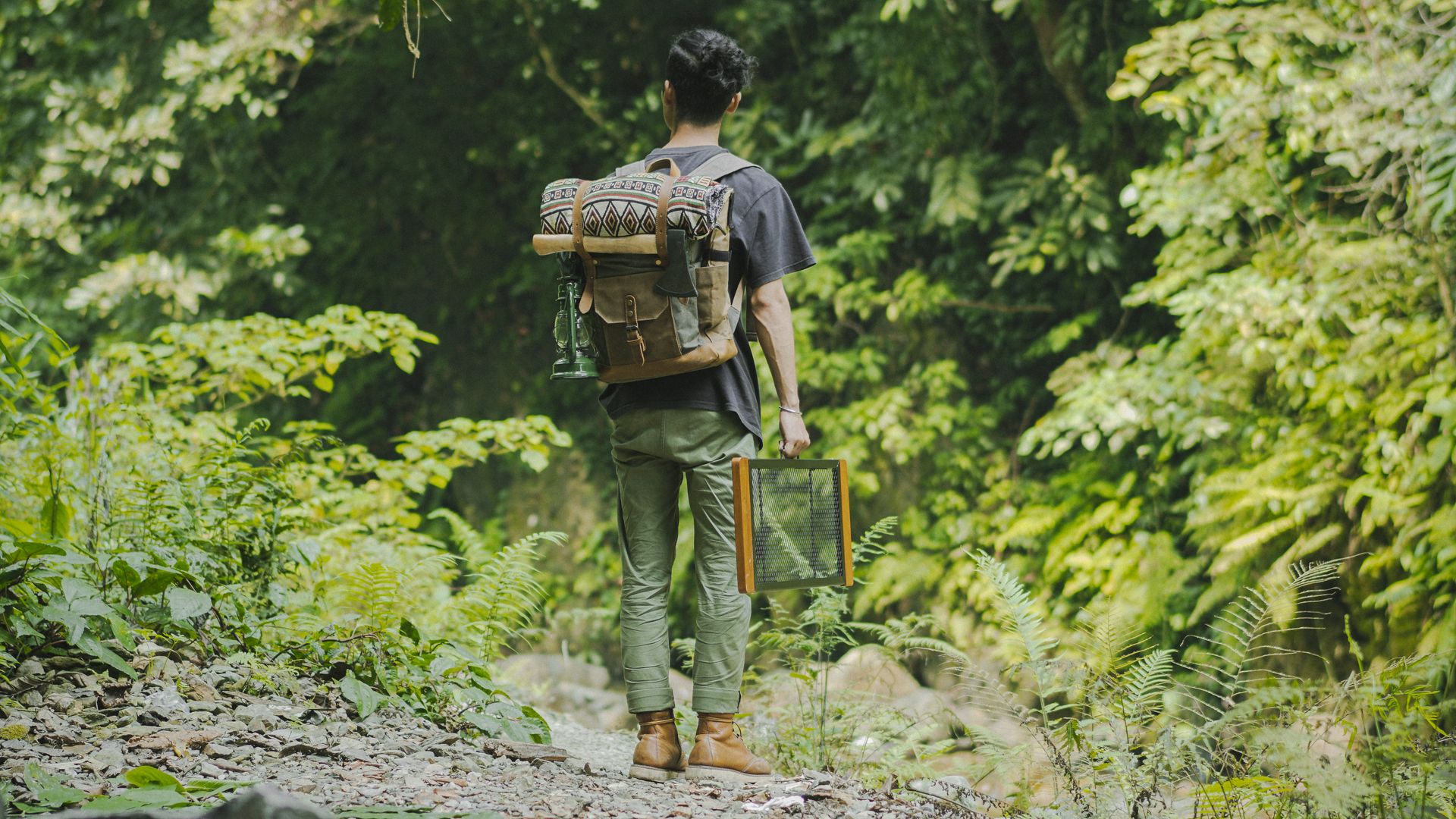 Man with a Backpack Carrying his Things While in the Forest