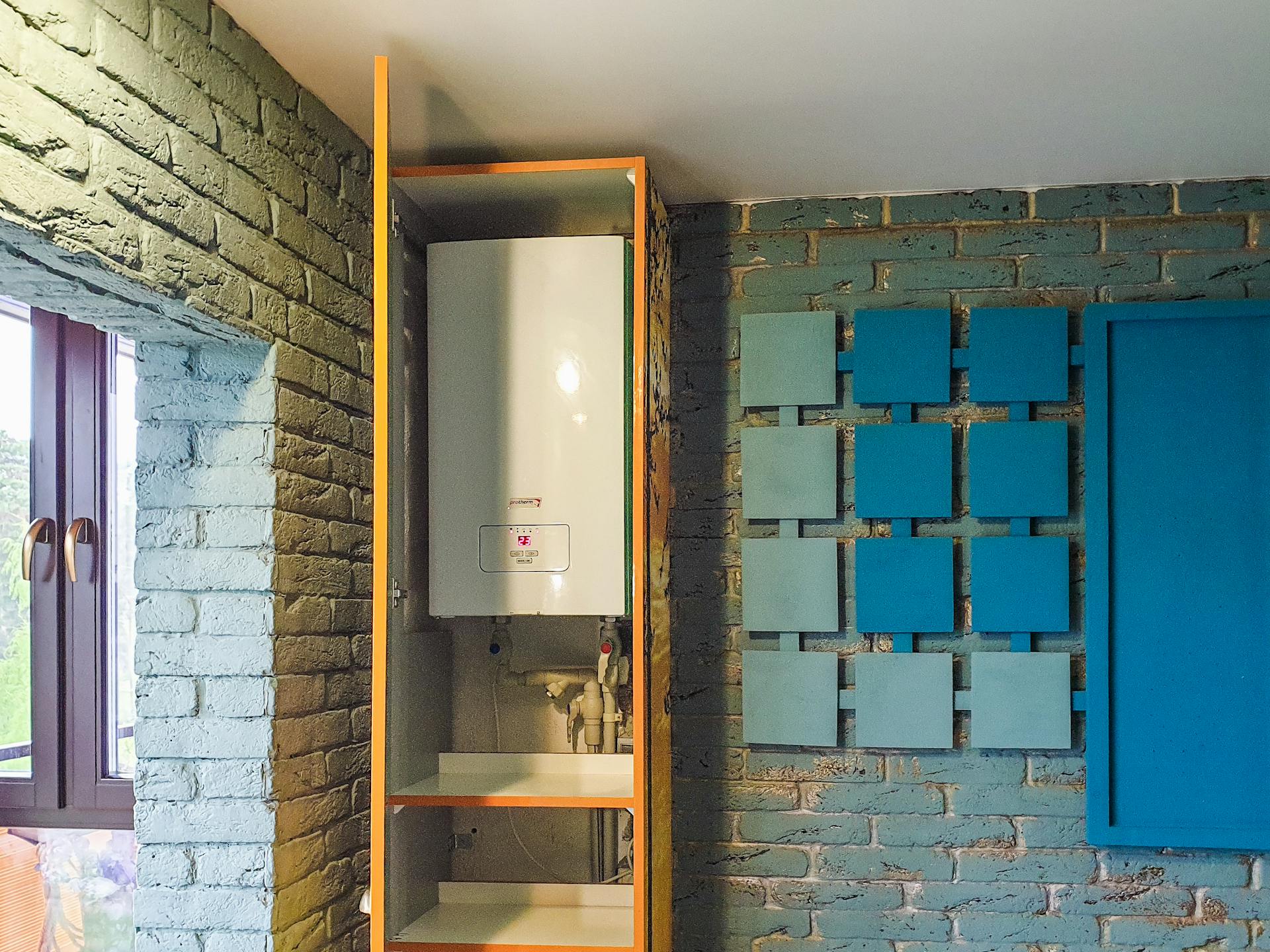 Indoor view of a water heater neatly installed in a cabinet with modern decor.