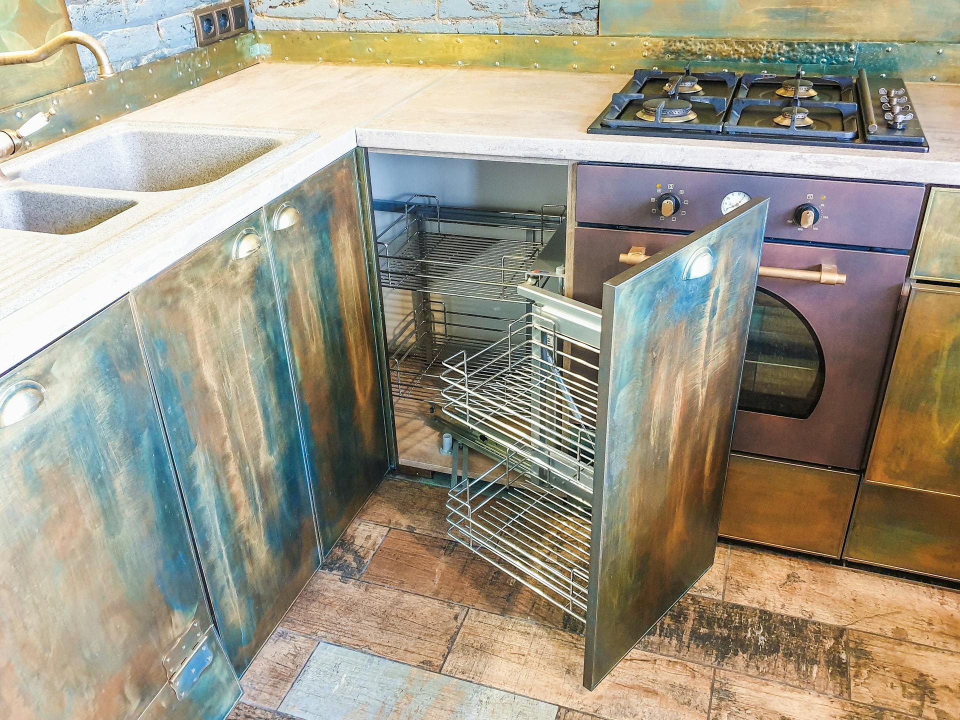 A modern kitchen featuring rustic metal cabinets and a gas stove, highlighting innovative interior design.