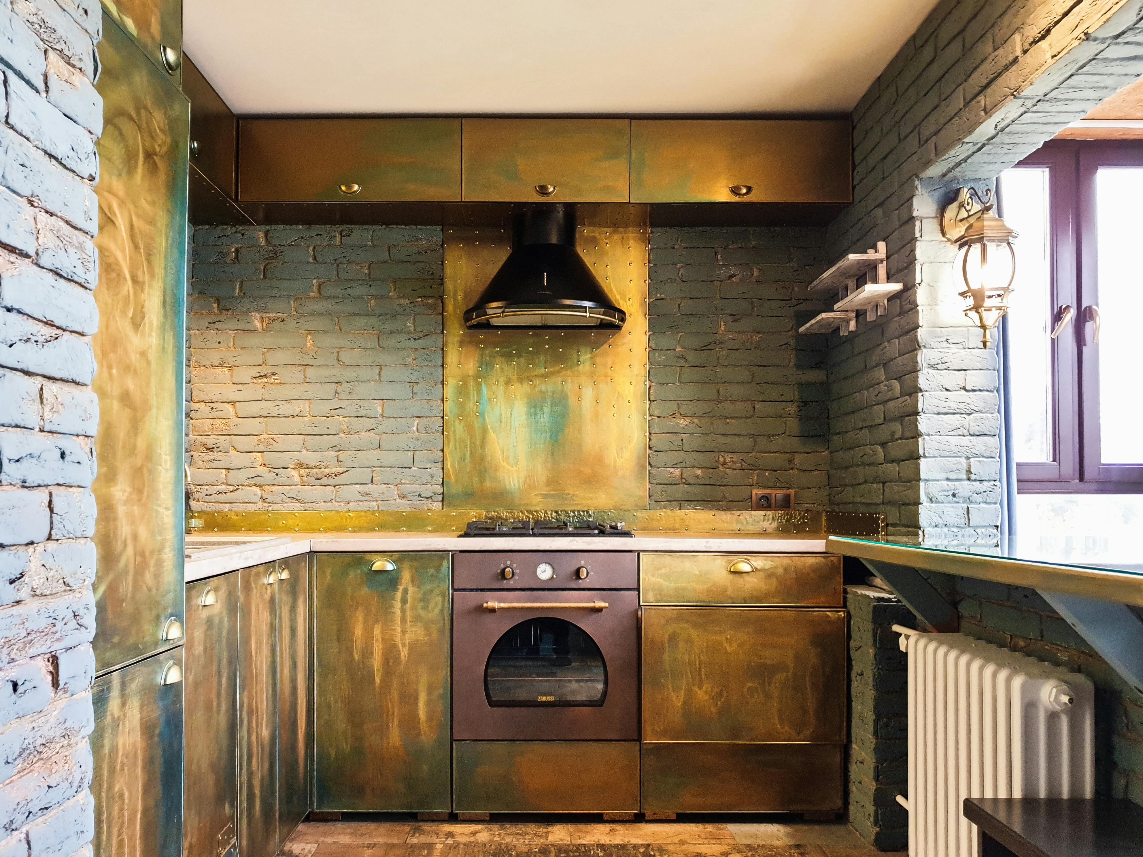 kitchen with copper sheet behind the stovetop