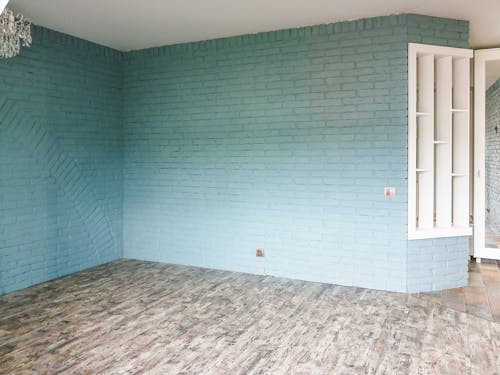 Blue Brick Wall and Wooden Flooring on a Room
