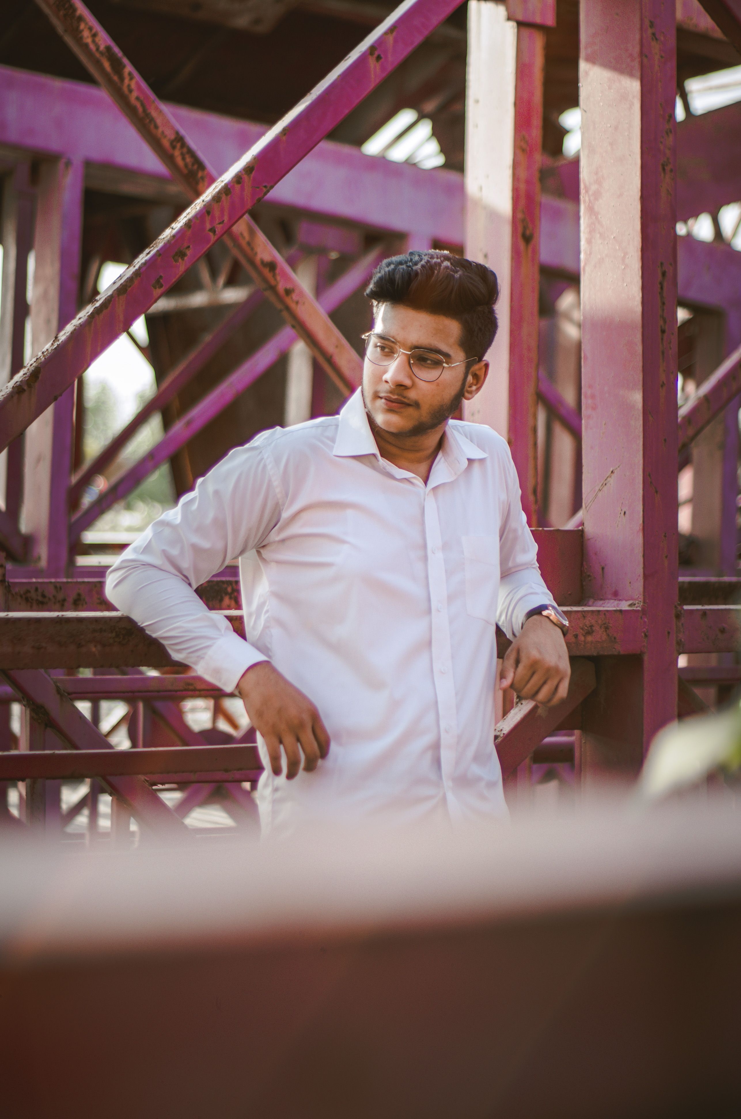 Man Wearing Sunglasses Leaning on Railing · Free Stock Photo