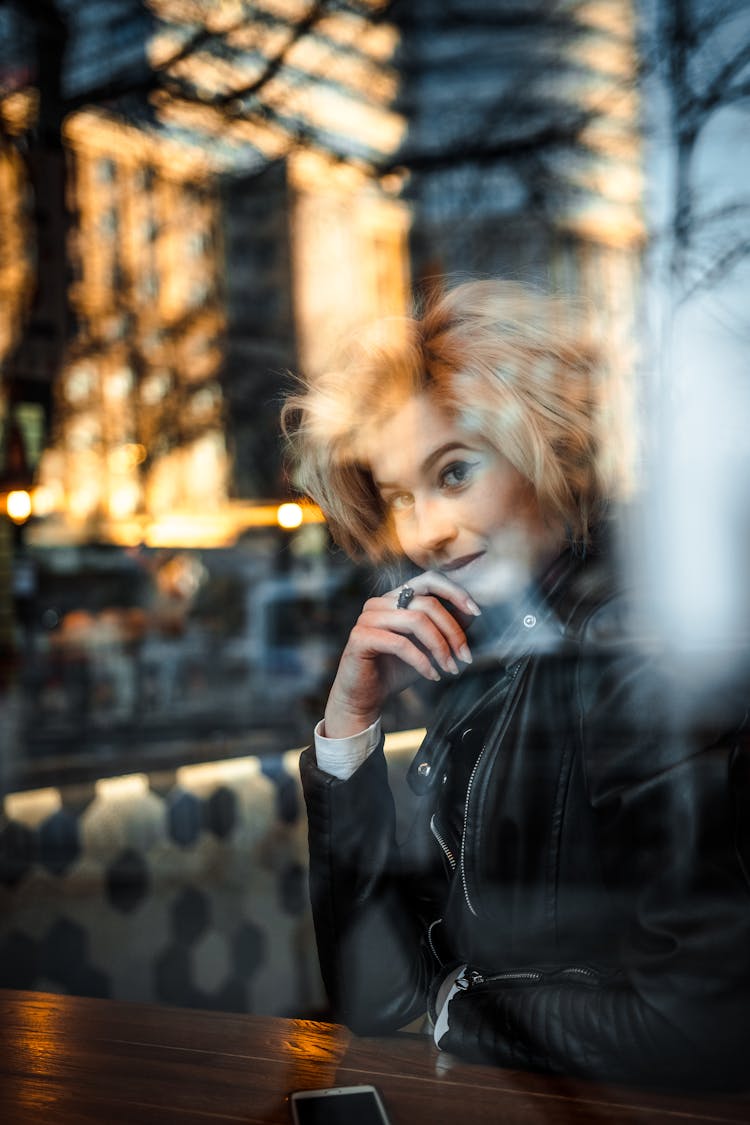 Woman In Black Leather Jacket Behind The Glass