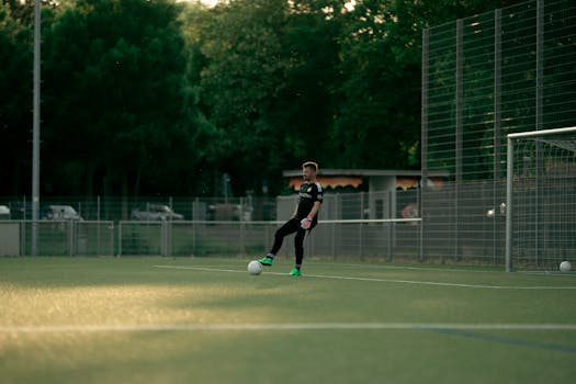 A soccer player in action on a green outdoor field, perfect for sports-themed content.