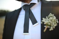 Untied Bow Tie of a Man with Flowers on the Coat