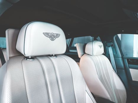 Elegant close-up of Bentley car interior highlighting luxury seats and design.