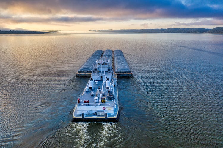 Aerial Photography Of A Barge On The Ocean During Sunset