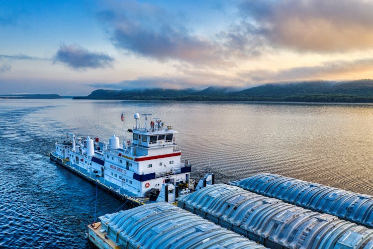 High-Angle Shot Of A Barge On The Ocean During Sunset