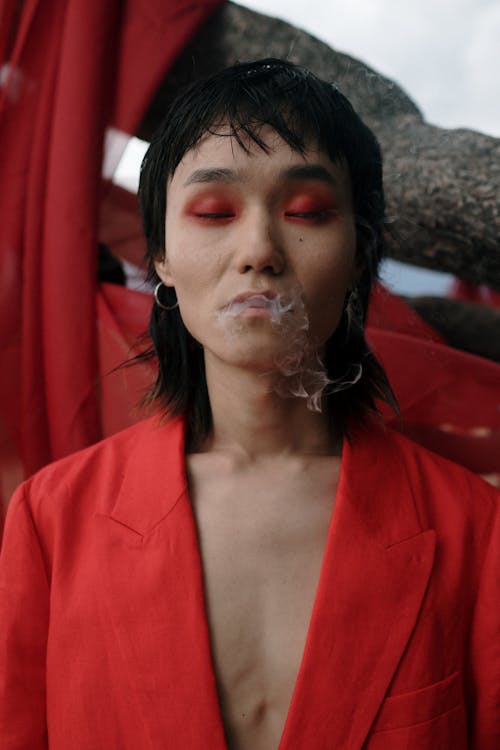 Woman in Red Blazer With White Bubble on Her Face