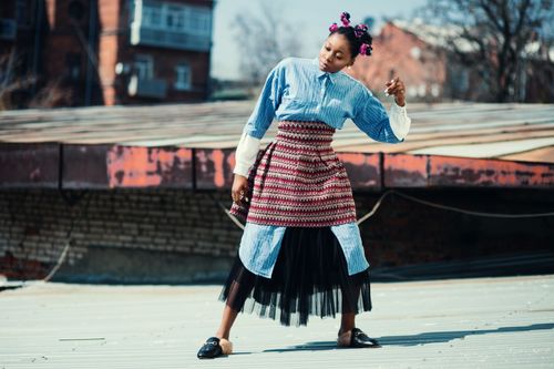 Free Dynamic shot of a stylish model posing on a rooftop in urban Ukraine. Stock Photo