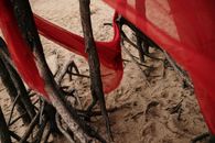 Red Plastic Bag on Brown Sand