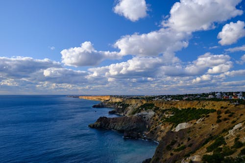 Sea Coast Under Blue Sky and White Clouds