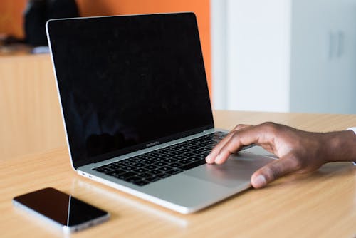 Person's Hand on Macbook Pro