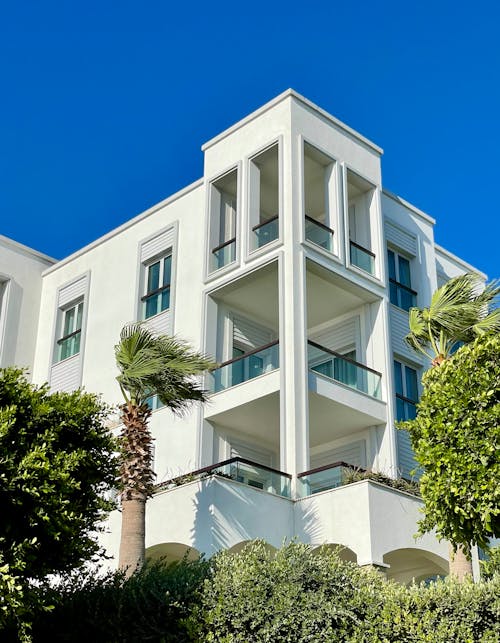 White Concrete Building with Glass Railings 