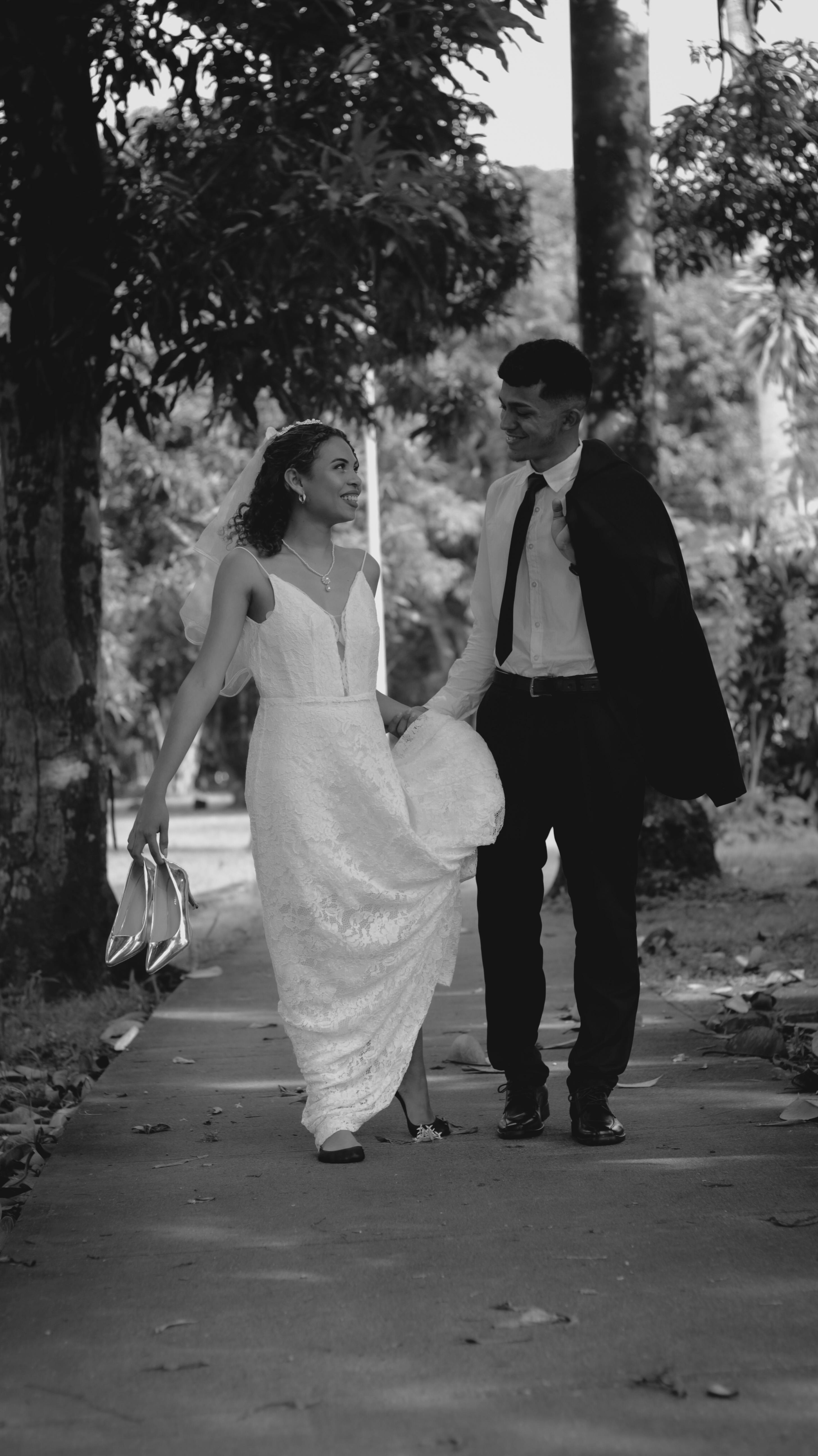 A Bride and Groom Standing on a Rock Formation at the Beach while ...