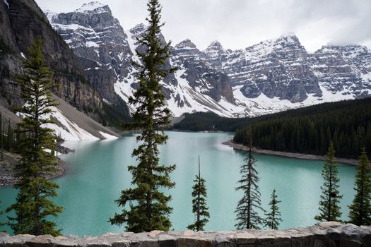 Breathtaking view of Moraine Lake with snow-capped mountains in Banff, Alberta, Canada.