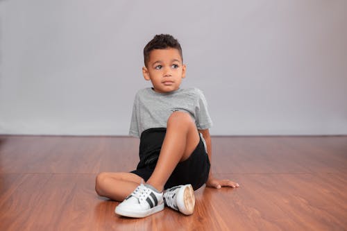 Free A Boy Wearing Gray Shirt and Black Shorts Stock Photo