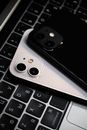 Black and White iPhones on a Keyboard