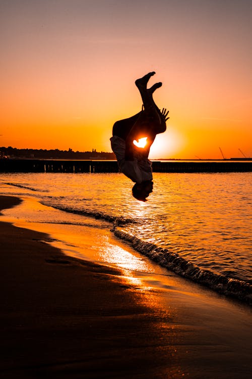 Free Silhouette of a Man Doing a Backflip Stock Photo