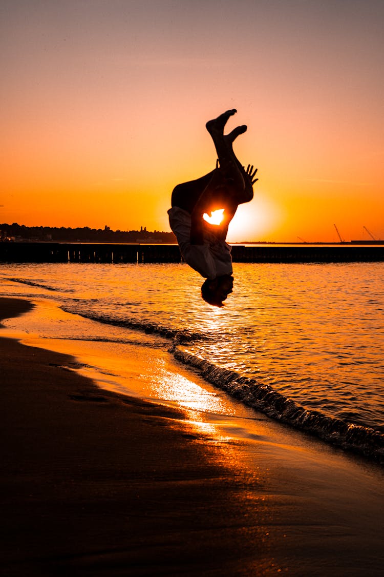 Silhouette Of A Man Doing A Backflip