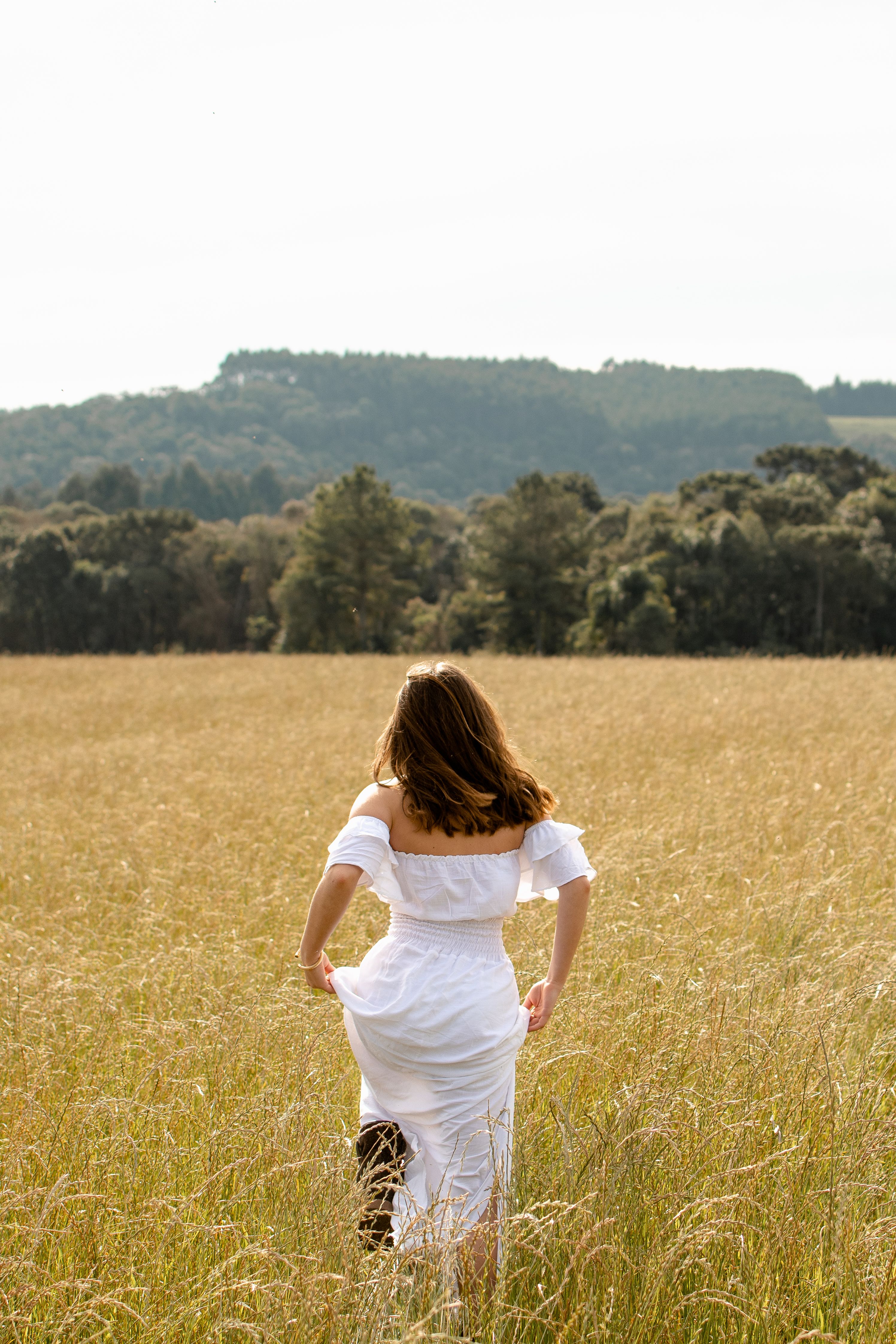 Woman in White Dress Standing on Grass Field · Free Stock Photo