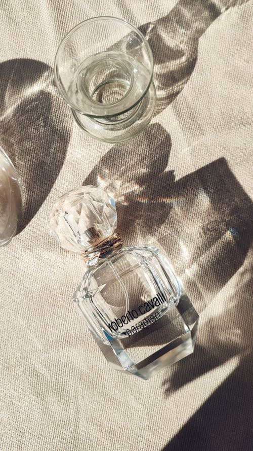 Free Clear Glass Bottle on White Textile Stock Photo